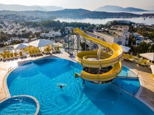 a swimming pool with a slide at a resort at Afytos Bodrum in Mugla
