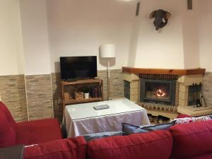 a living room with a couch and a fireplace at Carataunas House Alpujarra in Carataunas