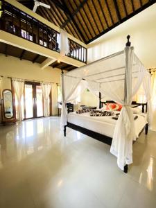 a bedroom with a large bed in a room at Tradisi Villas in Amed