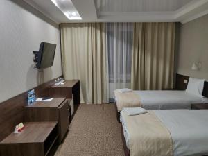 Postel nebo postele na pokoji v ubytování Sofievsky Posad Hotel