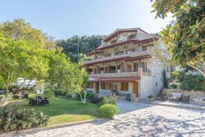 a large house with a garden in front of it at Dallas Valtos Studios in Parga