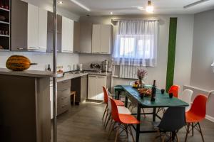 a kitchen with a table and chairs in a kitchen at Stone Art Guest House & Camping in Pemzashen