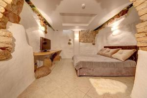 a bedroom with a bed and a desk and a tv at Vilnius Old town apartments in Vilnius