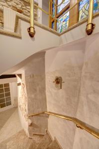 a staircase in a house with a stained glass window at Vilnius Old town apartments in Vilnius +19 photos