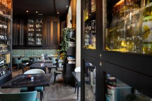 a restaurant with tables and chairs and a bar at Living Suites in Milan +33 photos