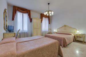 Postel nebo postele na pokoji v ubytování Hotel Bernardi Semenzato
