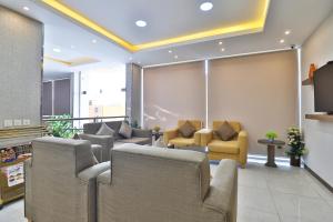 a waiting room with couches and chairs at شقق نجمة نوارة للشقق المخدومة - إقتصادي - Najmat Nawara For Serviced Apartments - Economy in Najran