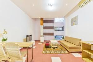 a living room with a couch and a table at Annie Danang Hotel & Apartment in Danang