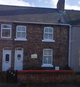 a brick house with white doors and windows at Ashington Home from Home in Ashington