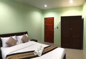 a bedroom with a bed with white towels on it at Anacar Bungalows in Krabi town