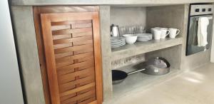 a wooden door in a kitchen with plates and dishes at Evie Cottage in Bioche