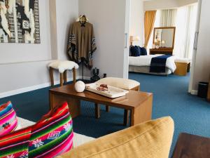 a hotel room with a table and chairs and a bed at San Miguel Plaza Hotel All Inclusive in Villa San Miguel +85 photos