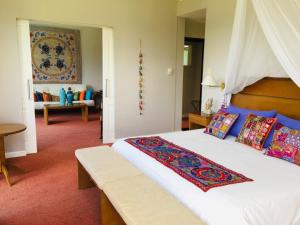 a bedroom with a large bed with a wooden headboard at San Miguel Plaza Hotel All Inclusive in Villa San Miguel