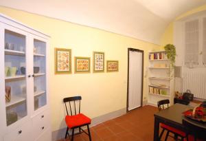 a dining room with a table and chairs and shelves at Luisa in Palazzo Bianchi in Parma