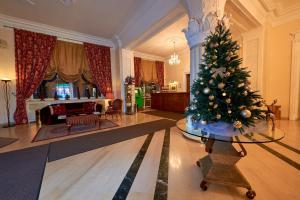 een kerstboom in het midden van een woonkamer bij Grand Hotel Ukraine in Dnipro