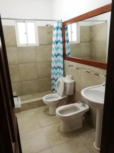 a bathroom with two toilets and a sink at Tropical Caribe in Bayahibe