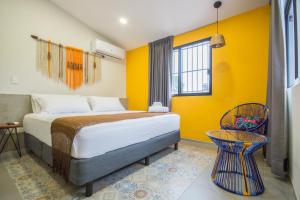 En eller flere senge i et værelse på Hotel Boutique Casa Xaan