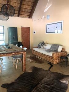 a room with a rattan bed and a table at Lion Hill @Kruger in Marloth Park