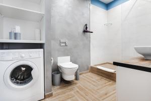 La salle de bains est pourvue d'un lave-linge et de toilettes. dans l'établissement CityApartments Kyiv Akademmistechko, à Kiev