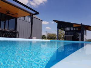 a large swimming pool in front of a building at Nordic Cabin and The Pool in Ban Sap Noi