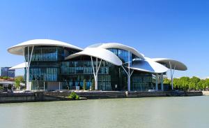 a large building next to a body of water at Guest House Lion in Tbilisi City