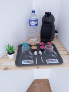 a tray with a bottle of water and utensils on a shelf at la casa de las palmeras in Arrecife