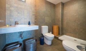 a bathroom with a toilet and a sink and a tub at Magnificent apartment close to the beach in Barcelona +9 photos