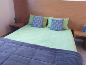 a bed with pillows and pillows on it at Residences La Tonnara in Bonifacio