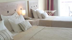 A bed or beds in a room at Erytha Hotel & Resort Chios