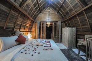 a bedroom with a large bed with red roses on it at The Lebak Canggu in Canggu