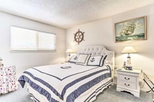 a white bedroom with a bed and a window at Wine Country Oasis with Waterfront Terrace and Dock! in Clearlake Oaks