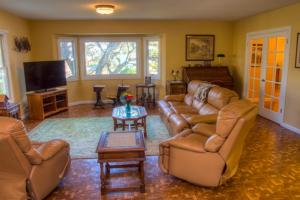 a living room with couches and a flat screen tv at Historic Petaluma Vacation Rental on Vintage Farm! in Petaluma