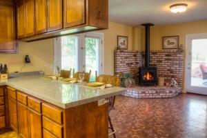 a kitchen with a counter top and a fireplace at Historic Petaluma Vacation Rental on Vintage Farm! in Petaluma