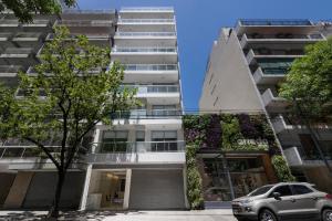 an apartment building with a car parked in front of it at Top Rentals Palermo Chico in Buenos Aires