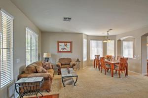 a living room with a couch and a table at Queen Creek Home Private Pool and Golf Course View! in Queen Creek