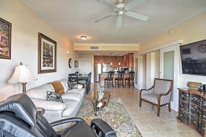 a living room with a couch and a table at Beachside Biloxi Club Condo Balcony with Ocean View in Biloxi