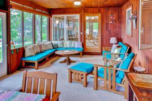 a living room with a blue couch and chairs at Spacious Brainerd Home by Dwtn - Summer Paradise! in Brainerd