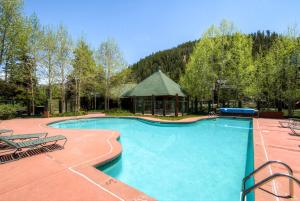 a large swimming pool with chairs and a gazebo at Hot Tub and Grilling Area Keystone Townhome! in Keystone