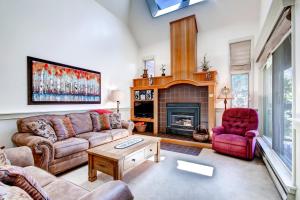 a living room with a couch and a fireplace at Hot Tub and Grilling Area Keystone Townhome! in Keystone