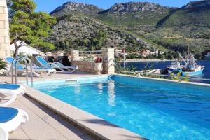 a swimming pool with a view of the water and mountains at Villa Silencia in Trstenik