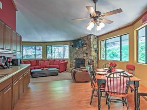 a kitchen and living room with a couch and a table at Unique Gatlinburg Cabin Decks, Hot Tub, Fire Pit in Gatlinburg