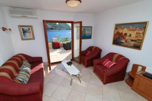 a living room with two couches and a table at Villa Silencia in Trstenik