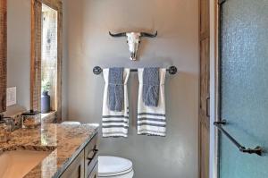a bathroom with two towels and a cow head on the wall at Rustic Chic Home 10 Mi to Otter Creek State Park! in Circleville +17 photos