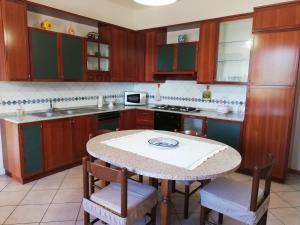 a kitchen with a table with chairs and a counter top at Casa La Fonte in Altopascio