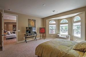 a bedroom with a bed and a living room at Roomy Home with Deck, 5 Mi to Lake Arrowhead Village in Lake Arrowhead