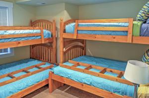 a room with three bunk beds and a desk at Gorgeous Wapato Point Lakehouse with Private Hot Tub in Manson