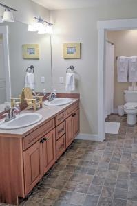 a bathroom with two sinks and a toilet at Gorgeous Wapato Point Lakehouse with Private Hot Tub in Manson +21 photos