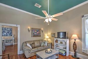 a living room with a ceiling fan and a couch at Charming Gulfport Getaway Only 3 Blocks to Beach! in Gulfport