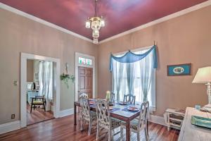 a dining room with a table and chairs and a chandelier at Charming Gulfport Getaway Only 3 Blocks to Beach! in Gulfport