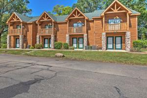 a large log home with a gambrel at Cozy Townhome, Half Mi to Starved Rock State Park! in Utica